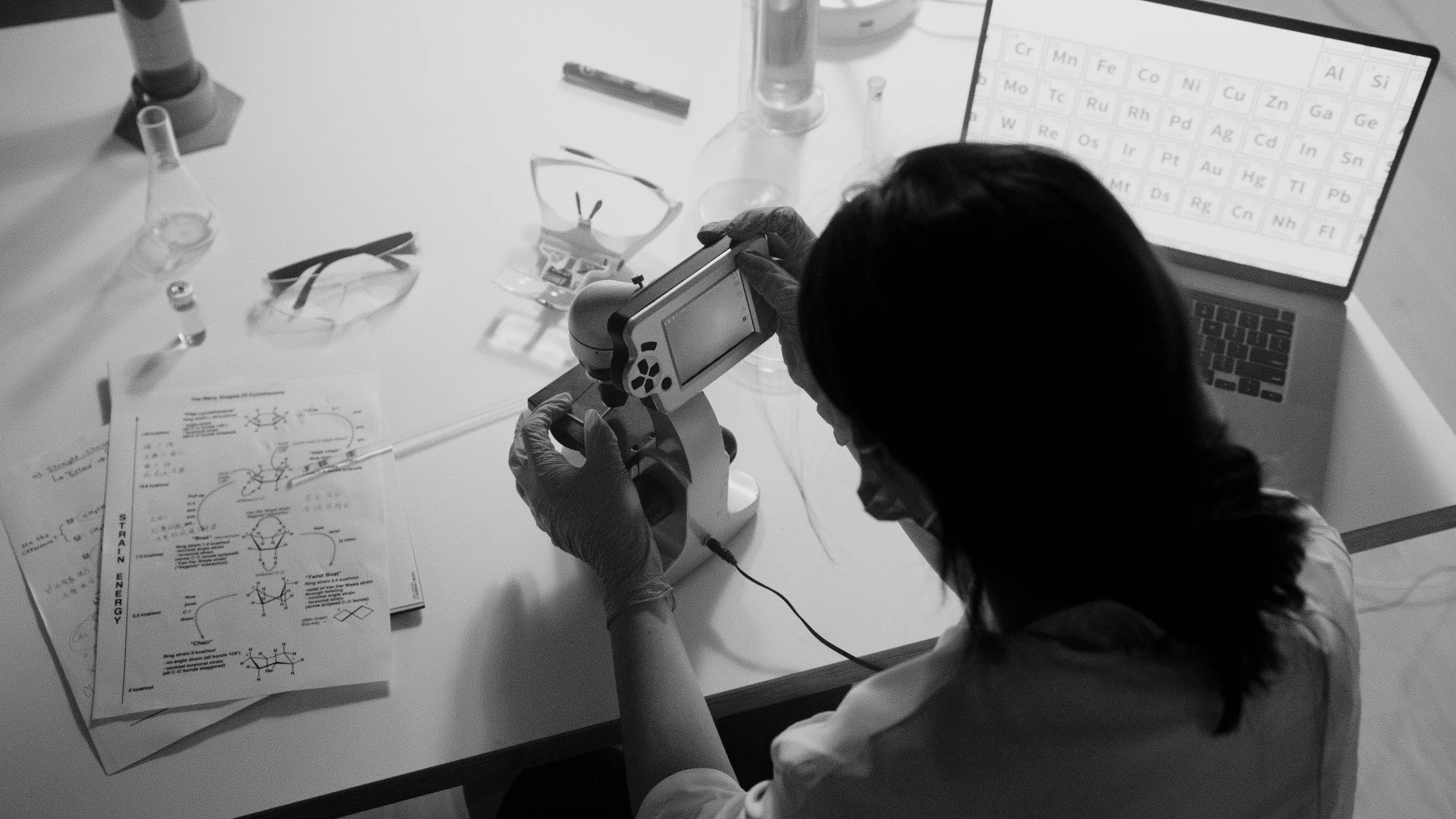 A clinician taking a measurement at a laboratory bench